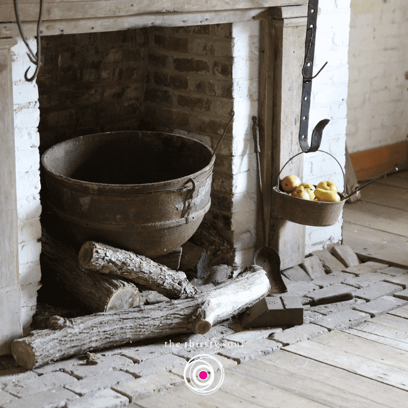 A brick fireplace adorned with a pot, evoking the essence of Samhain.